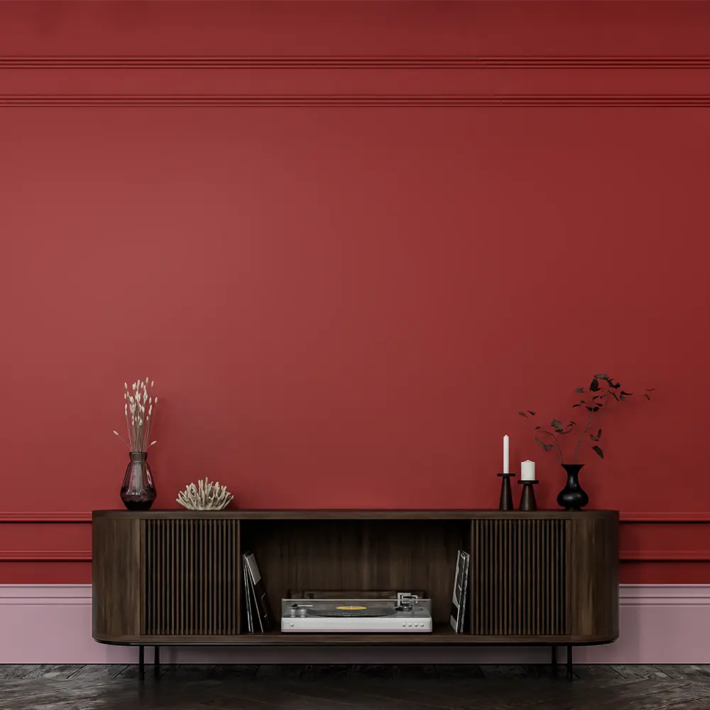 Modern living room featuring a rich red wall painted with Nippon Paint, complemented by a stylish wooden console table displaying decorative items and a record player.