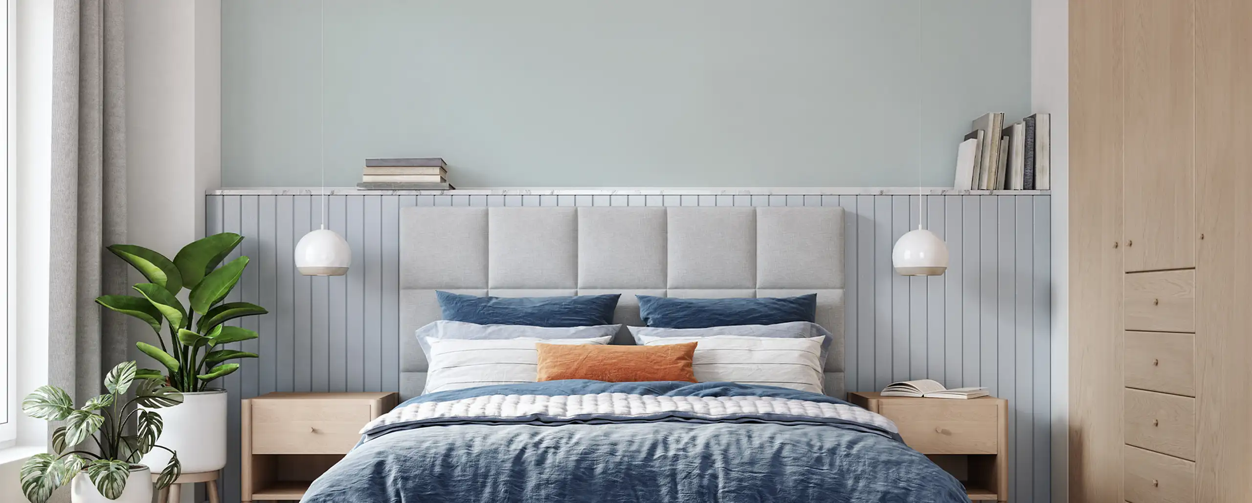 Bedroom with pastel blue interior wall, cabinet and side table