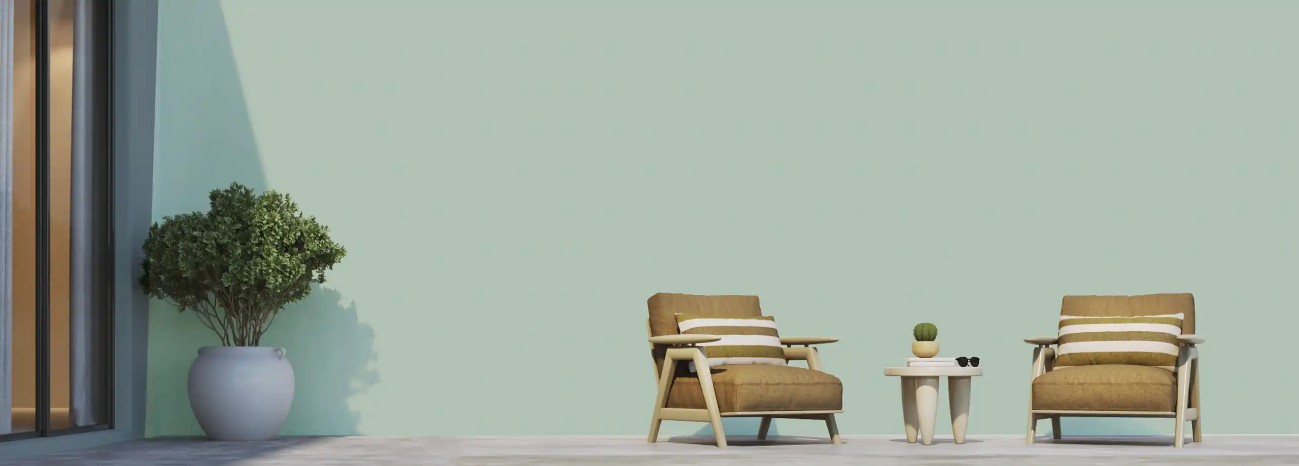 Cozy outdoor seating area featuring a stylish armchair and a small table against a soft green wall painted with Nippon Paint. The space is enhanced by a potted plant, creating a serene and inviting atmosphere.