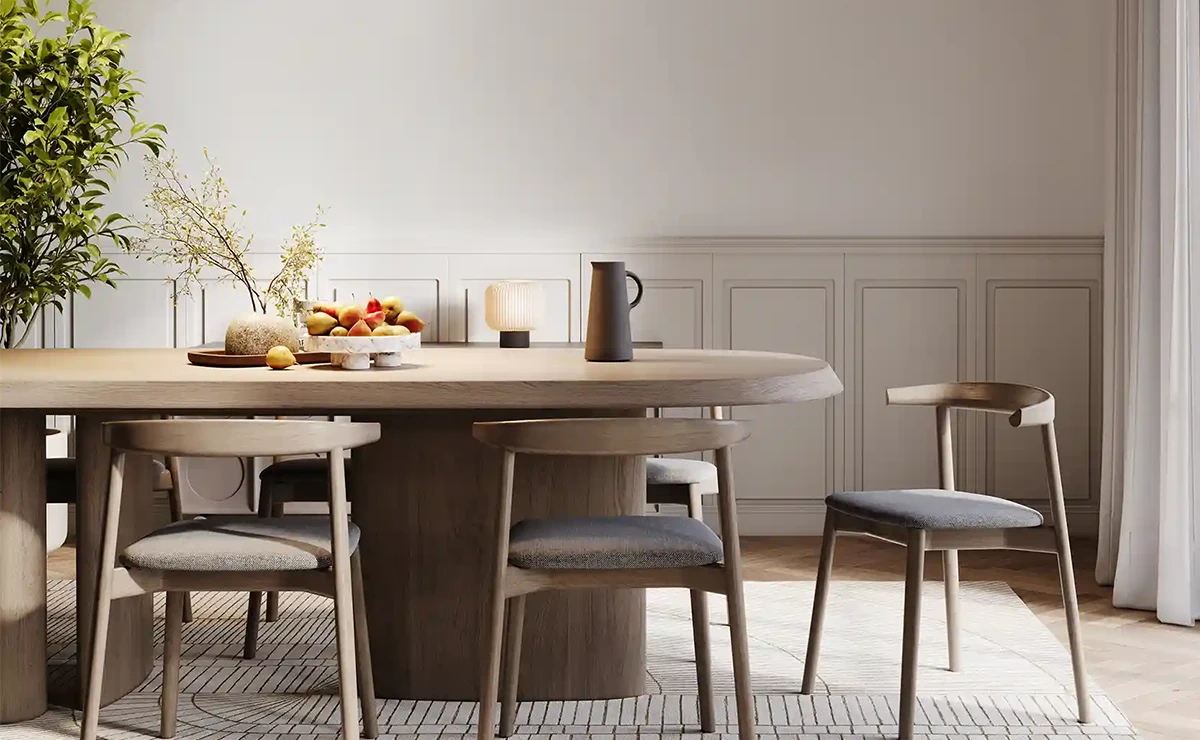 Contemporary dining area featuring a wooden table and stylish chairs, adorned with a centerpiece of fresh fruits and decorative plants. The walls showcase a soft, neutral color palette enhanced by Nippon Paint products, creating a warm and inviting atmosphere.