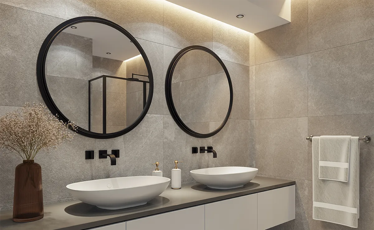 Modern bathroom with tiled walls, two round mirrors and sinks, featuring Nippon Paint NippoCEM Flex 1K 902 flexible waterproofing mortar.