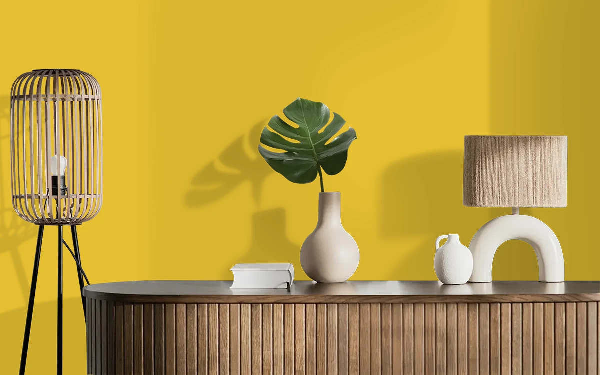 Nippon Paint's ANTIQUE BRASS color on different wall surfaces.